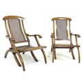 A pair of Edwardian stained beech folding ‘steamer’ style deck chairs, with caned seats and backs, 6... 