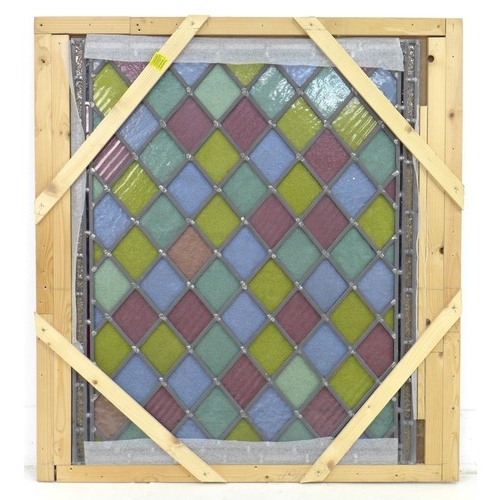 229 - A stained glass window, with yellow, red, blue and green diamond shaped leaded panes, in wooden ship... 