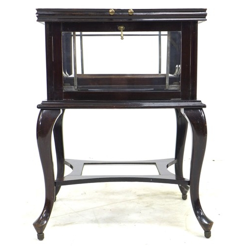 271 - An Edwardian mahogany cocktail cabinet, with glazed sides and top opening to reveal a rising removab... 