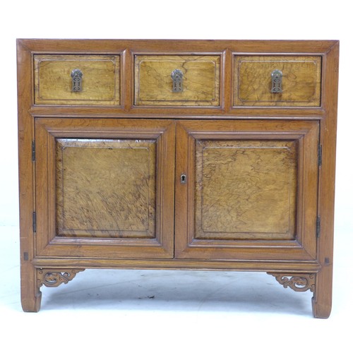 340 - A Chinese hardwood cabinet, early to mid 20th century, with three frieze drawers with veneered front... 