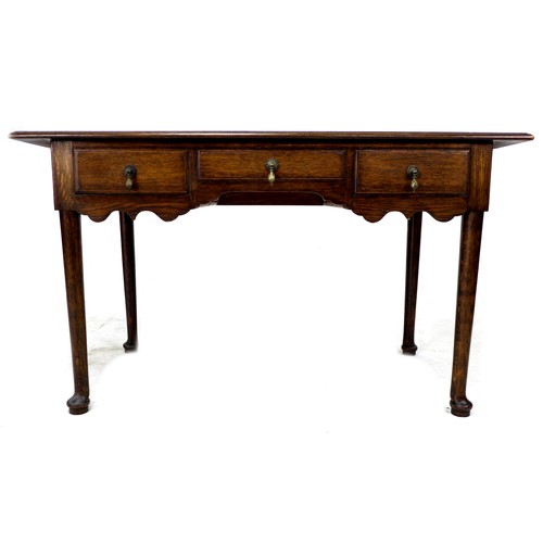 252 - An early 20th century oak side table, with three frieze drawers, brass drop handles, raised on cabri... 