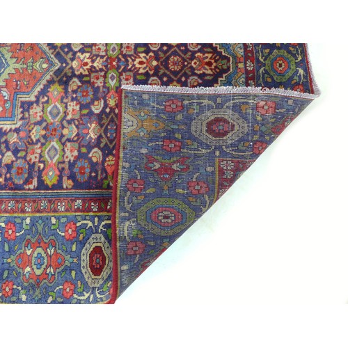 272 - A hand knotted wool Hamadan rug, with mulit coloured central medallion and profuse floral patterns u... 