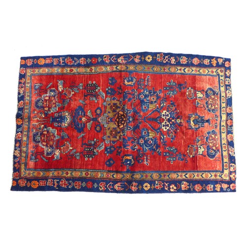 223 - A hand knotted wool Hamadan rug, with zoomorphic designs upon a red ground and with causcasian and b... 