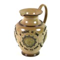 An Edwardian Doulton Lambeth harvest ware jug, decorated with four relief cast panels with bust meda... 