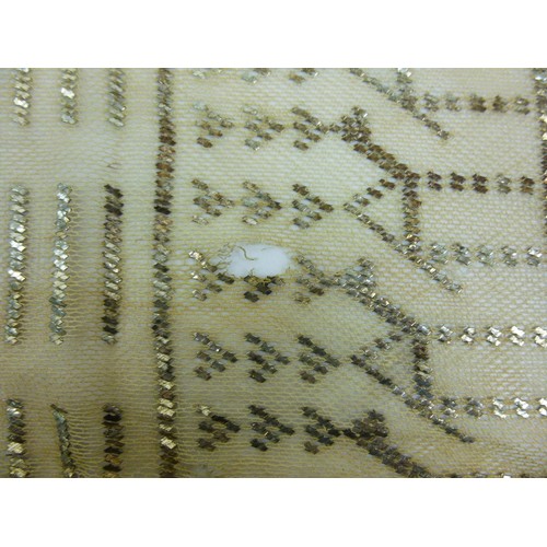 146 - A vintage Egyptian Assuit shawl, circa 1930, the cream net ground decorated with stylised figures an... 