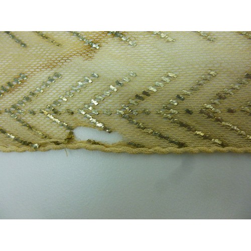 146 - A vintage Egyptian Assuit shawl, circa 1930, the cream net ground decorated with stylised figures an... 