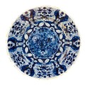 An 18th century Dutch blue and white tin glazed charger, decorated with three flower heads to the ce... 