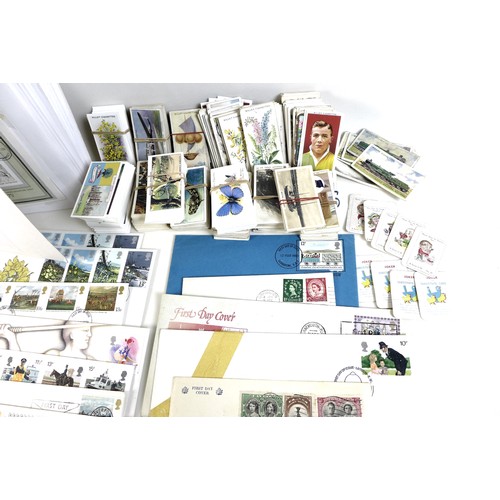 143 - A collection of First Day Covers, presentation packs and cigarette cards, the First Day Covers datin... 