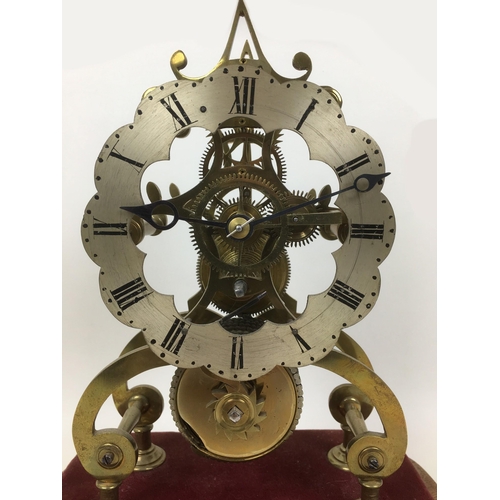115 - A 19th century skeleton clock with fusee movement, Roman numeral dial, fixed to velvet covered base ... 