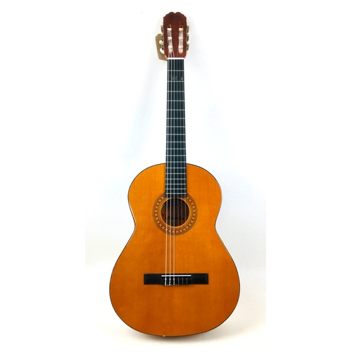 173 - A Spanish made classical guitar by Almeria, label to interior.