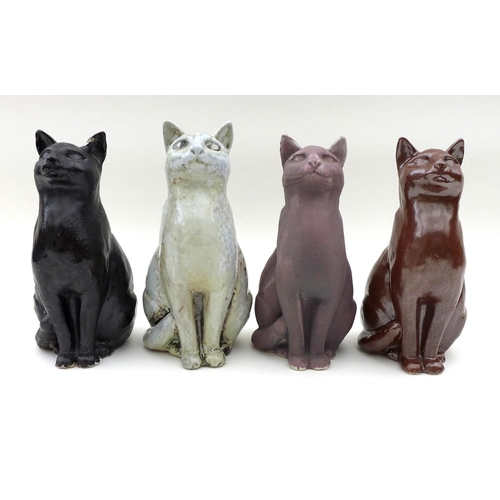25 - A group of North Shore pottery, comprising four ceramic cats two signed JMR on base, height of each ... 