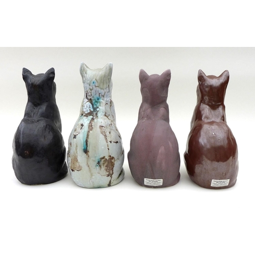 25 - A group of North Shore pottery, comprising four ceramic cats two signed JMR on base, height of each ... 