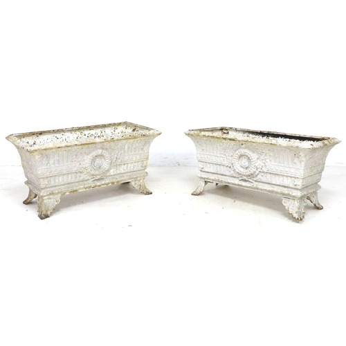 276 - A pair of early 20th century cast iron rectangular planters, each with four outswept feet, with dama... 