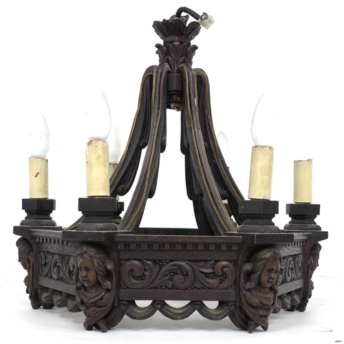 284 - A mid 20th century carved oak chandelier, of hexagonal form with swept supporting arms, carved with ... 