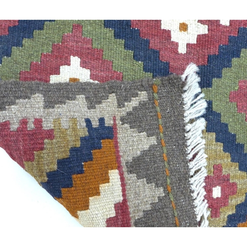 285 - A Maimana Kilim rug, with diamond patterned field in white, orange, green, burgundy, and dark blue, ... 