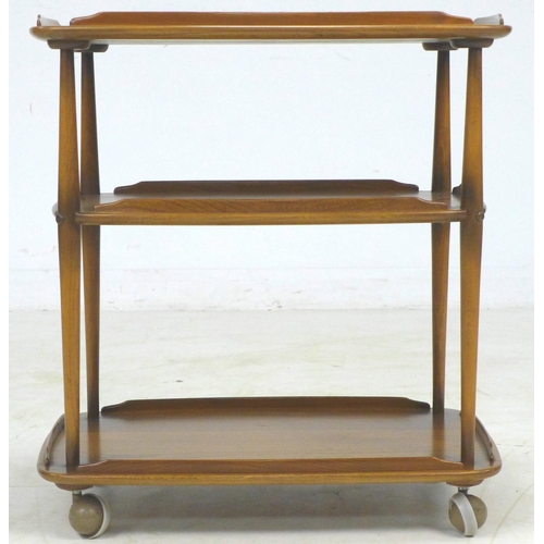 297 - An Ercol elm and beech cocktail drinks trolley, three tiers with small raised upstands, raised upon ... 