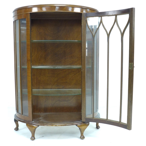 300 - A 1950's mahogany veneered demi-lune display cabinet, single astragal glazed door, three glass shelv... 