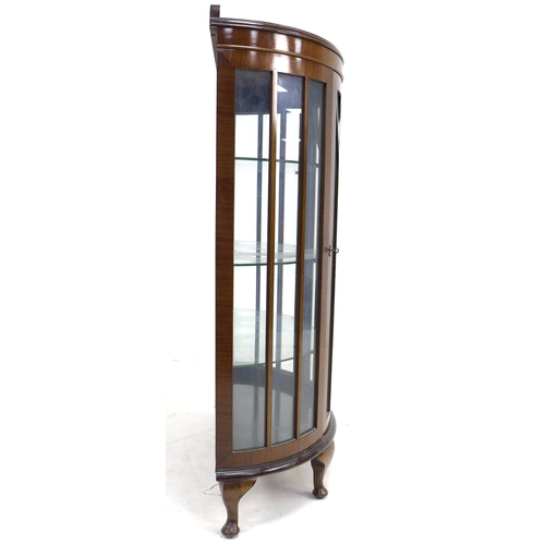 300 - A 1950's mahogany veneered demi-lune display cabinet, single astragal glazed door, three glass shelv... 