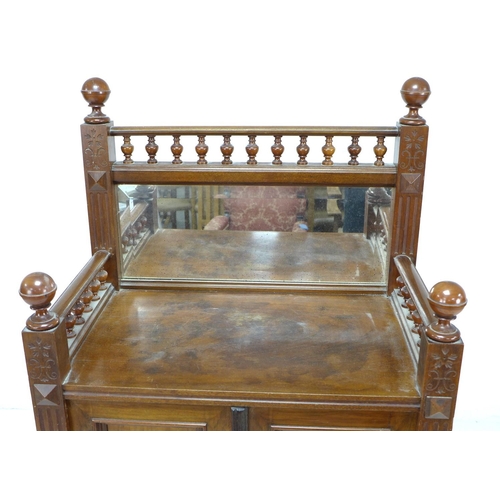 307 - A late 19th century Continental mahogany cabinet, with turned galley and mirrored upstand, twin door... 