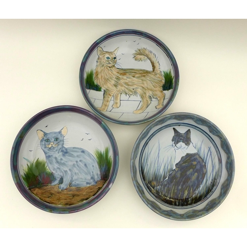 31 - A group of Highland Stoneware pottery, comprising three large bowls each depicting cats, two signed,... 