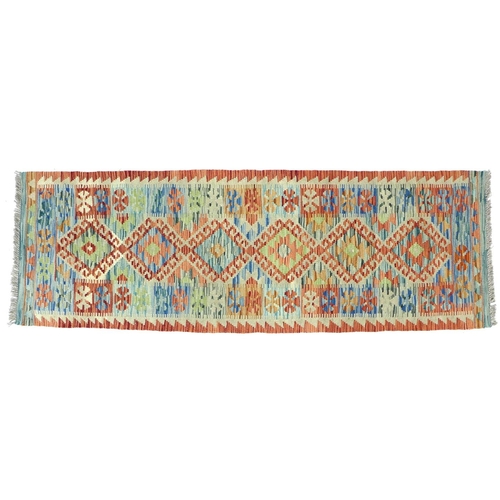 312 - A vegetable dyed wool Choli Kilim runner, with pale green ground and orange edges, with geometric de... 