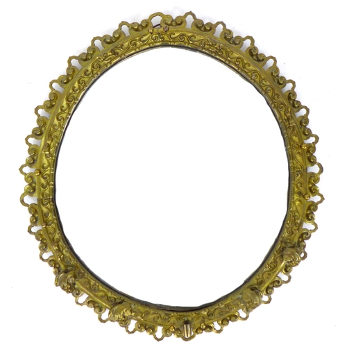 314 - An early 20th century gilt metal wall mirror, with open work scroll decorated frame surrounding an o... 