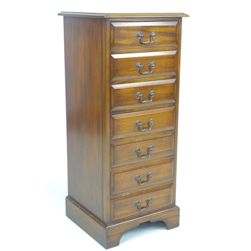 318 - A reproduction George III style semainier, being a narrow chest of seven drawers, raised on bracket ... 