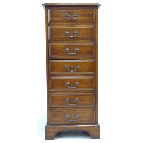 318 - A reproduction George III style semainier, being a narrow chest of seven drawers, raised on bracket ... 