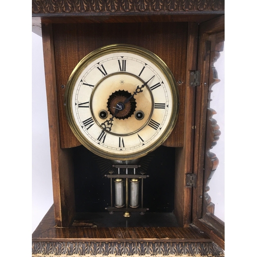 321 - A German Junghans stained pine cased mantel clock, with eight day movement, 'No. 3037', mercury styl... 