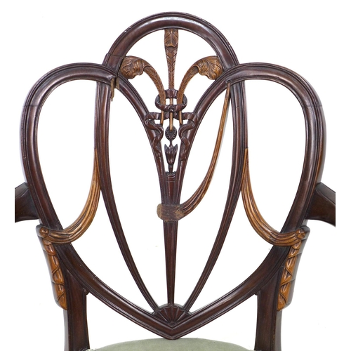 325 - An early 19th century mahogany open arm chair, after a Hepplewhite design, with open trefoil heart s... 