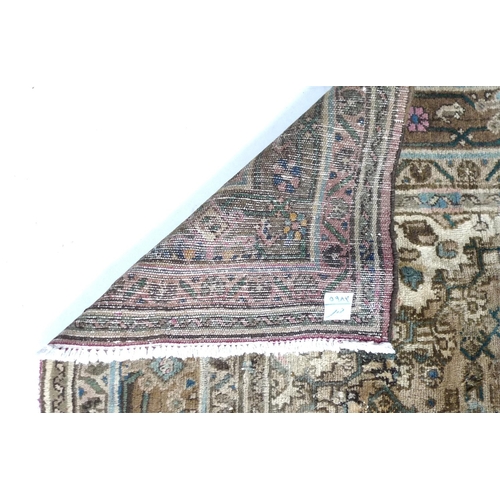 341 - A large Hamadan carpet, with multicoloured ground, central cream medallion and corners, floral field... 