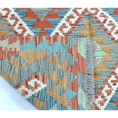 344 - A vegetable dyed wool Choli Kilim rug, with diamond patterned field separated by white latch hook li... 