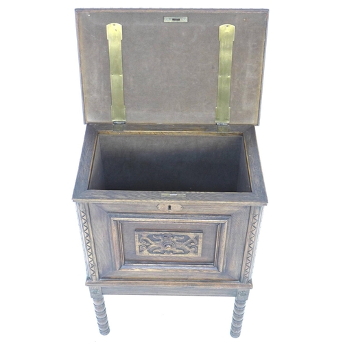 345 - A 20th century oak chest on stand, the lift lid with elm inlay and large brass hinges opening to rev... 