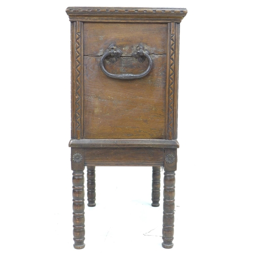 345 - A 20th century oak chest on stand, the lift lid with elm inlay and large brass hinges opening to rev... 