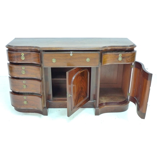 354 - A Victorian mahogany knee hole desk, of serpentine, breakfront outline, with six drawers and two cup... 