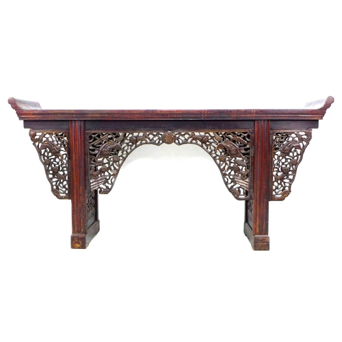 368 - A late 19th century Chinese altar table, the long surface with upturned ends, decorative pierced and... 