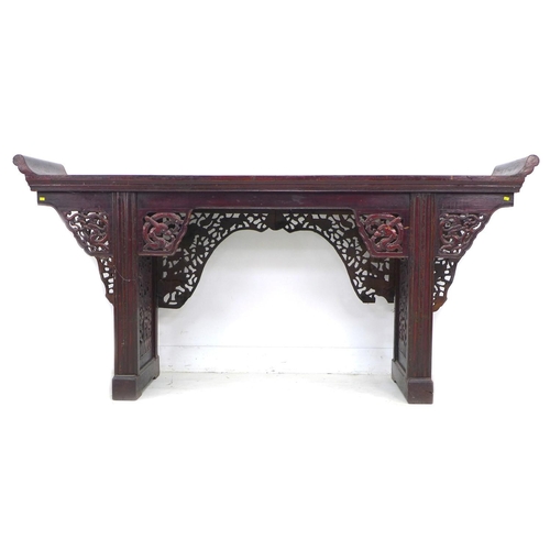 368 - A late 19th century Chinese altar table, the long surface with upturned ends, decorative pierced and... 