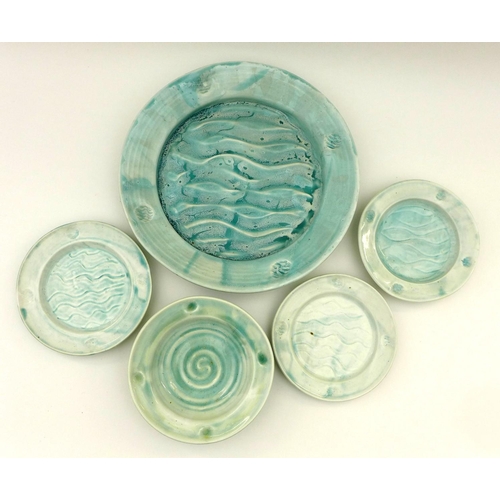 38 - A small group of North Shore pottery with an aquamarine glaze, one bowl, three small plates and, one... 