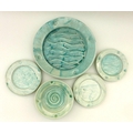 A small group of North Shore pottery with an aquamarine glaze, one bowl, three small plates and, one... 