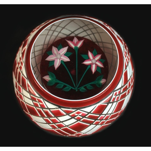 43 - A John Deacons paperweight, with red and white overlaid exterior emcompassing red and white flowers ... 