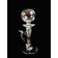 A 19th century clear glass lace maker's oil lamp, with spherical holed top above a drip pan, above a... 