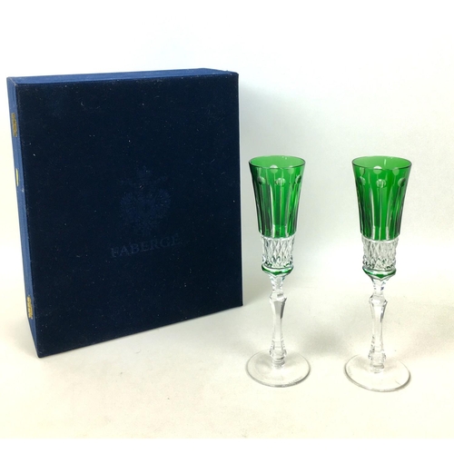 51 - A pair of 20th century Faberge Xenia emerald green glass champagne flutes, both with Faberge marks t... 