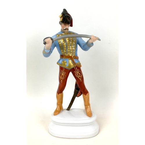 68 - A Herend figurine of a Hungarian dragoon, numbered 5526 and signed 'S' to its base, 10 by 6 by 23cm ... 