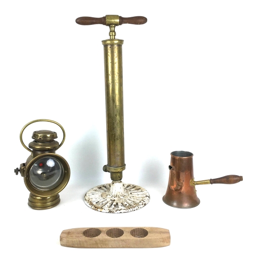 94 - A group of copper and brass items and kitchenalia comprising a brass fireman's pump with cast iron b... 