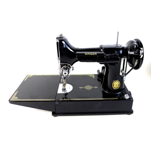 96 - A vintage Singer Featherweight 221K portable sewing machine, serial number EH244952, with fold out p... 