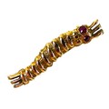 A WWII Caterpillar Club 9ct gold brooch, modelled as a silk worm, with inset ruby eyes, engraved to ... 