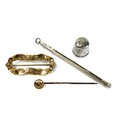 A 15ct gold topped stick pin with ruby style stone, 2mm diameter, and white metal pin, 5.5cm long, t... 