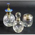Three silver and cut glass dressing table items, comprising a silver and enamel topped atomiser, sta... 