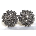 A pair of 9ct gold and white gold and diamond cluster earrings, of flowerhead design, with central d... 