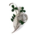 An 18ct white gold diamond and jade brooch, of foliate swirl design, the oval jade set as leaves, re... 